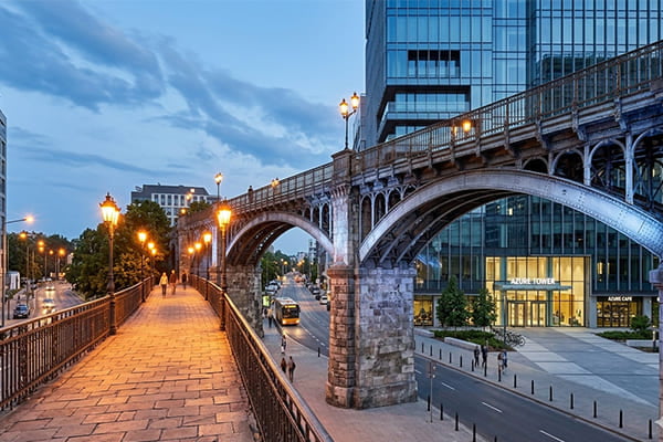 A historic bridge with cool light on the structure and warm light on the walkway